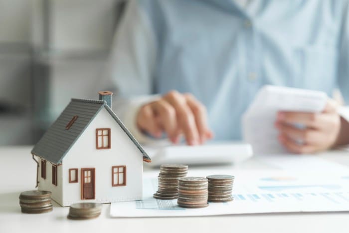 House and coins saving for buying an investment property